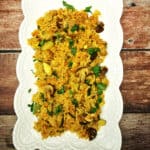 Curried Rice Sautee in white serving bowl