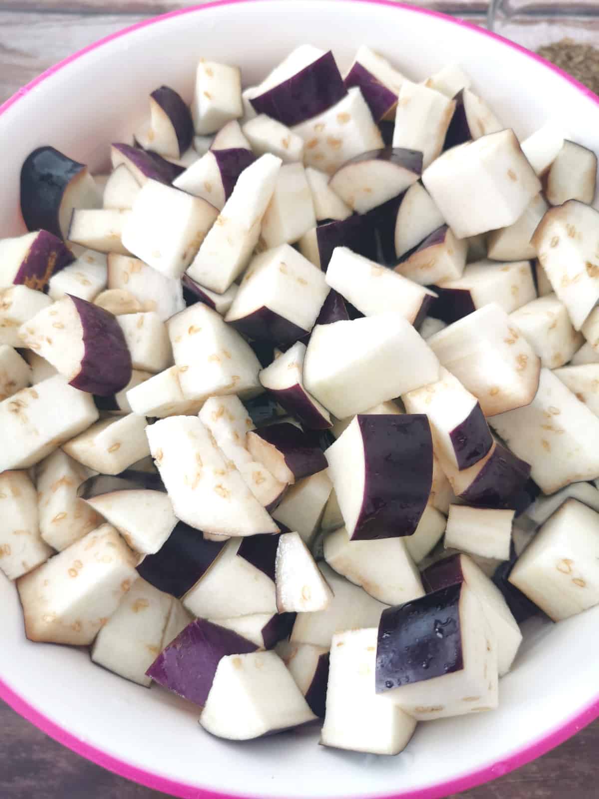 diced eggplant seasoned with salt, drizzled in lemon juice, in large mixing bowl