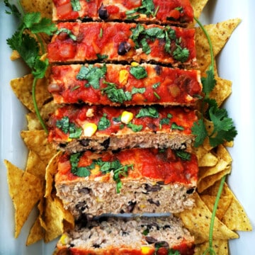 Sliced Mexican Style Meatloaf with tortilla chios and cilantro on the side