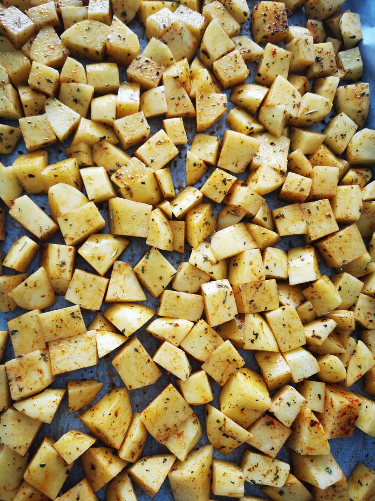 Potato Cubes seasoned and placed on baking sheet