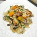 Parmesan Pasta and Roasted Vegetables in a white plate.