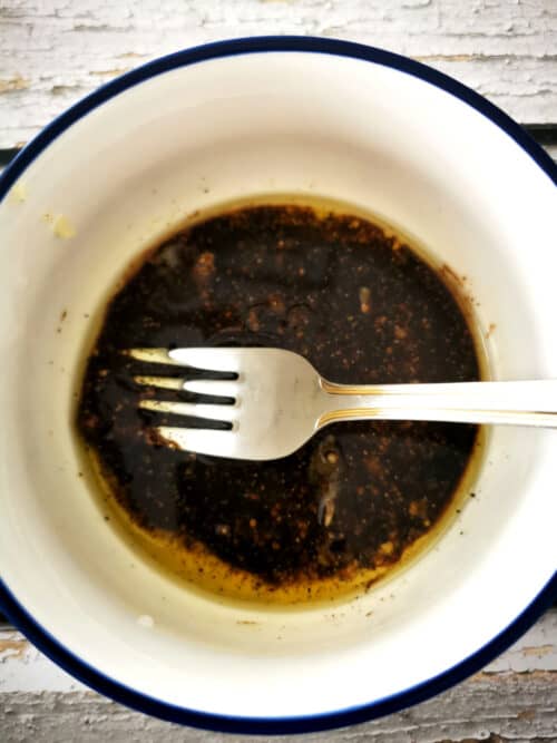 balsamic dressing in a small mixing bowl whisked with fork