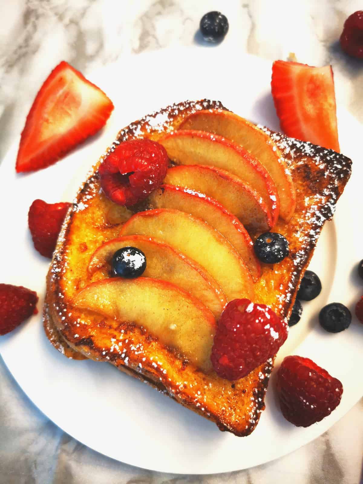 Apple Cinnamon French Toast with blueberries, strawberries and raspberries
