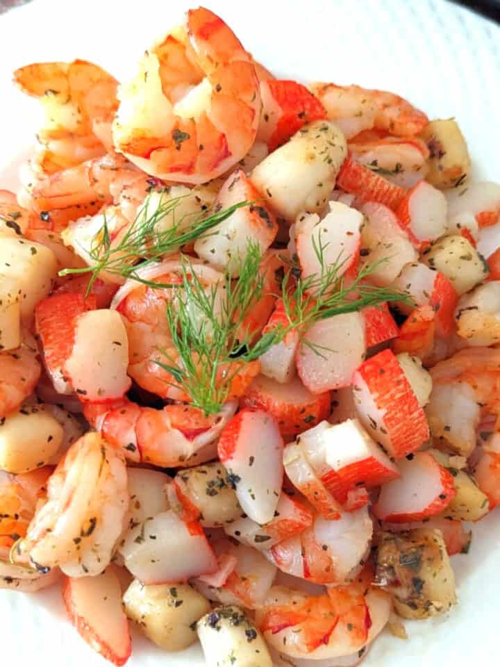 Sauteed Seafood Medley on white plate closeup