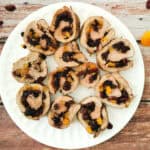 pork and dried fruit roll on a white serving plate.