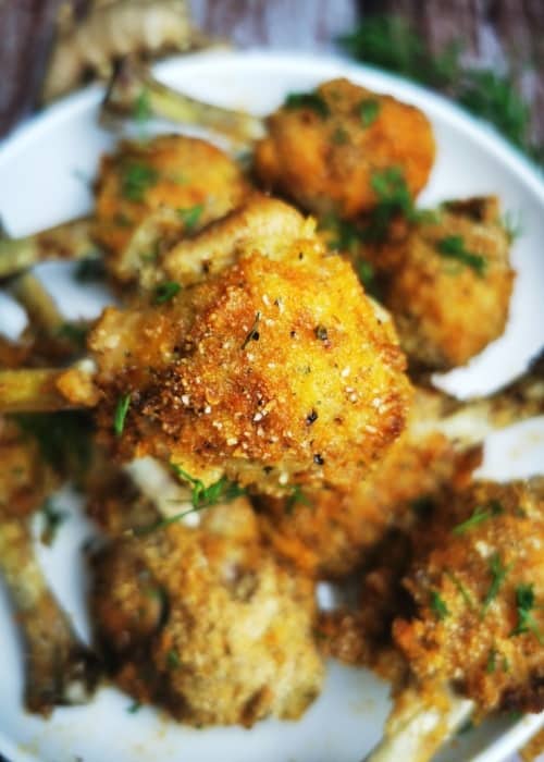 baked crispy chicken drumstick with dill sprinkled on top