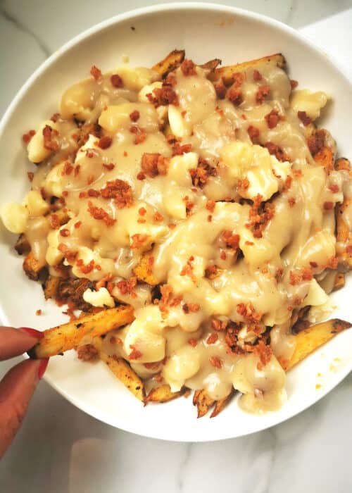healthier oven-baked poutine on white serving plate