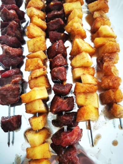 pineapple and beef pieces on skewers