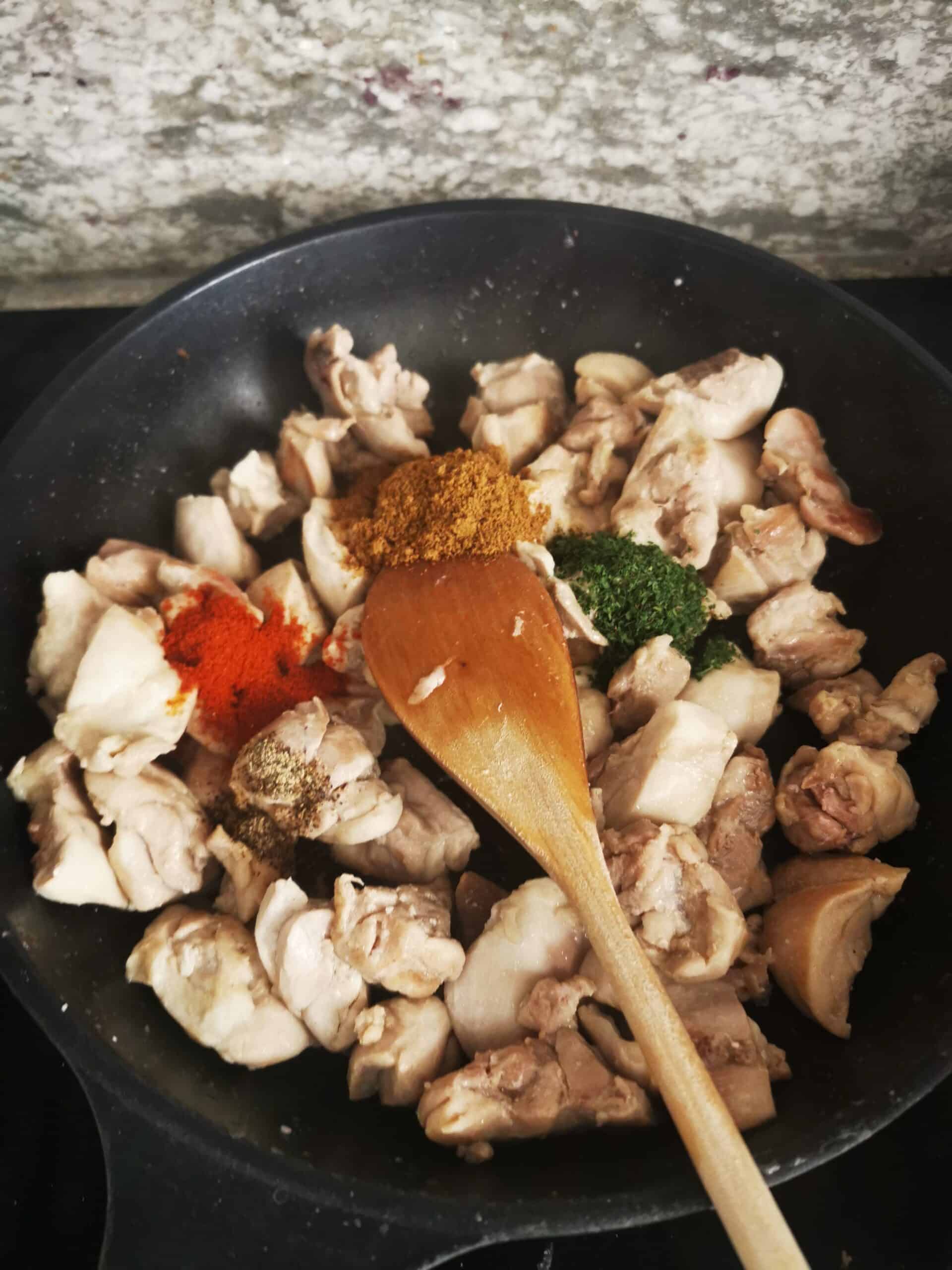 Stir-Fried Chicken Thighs in pan over stove, add seasonings