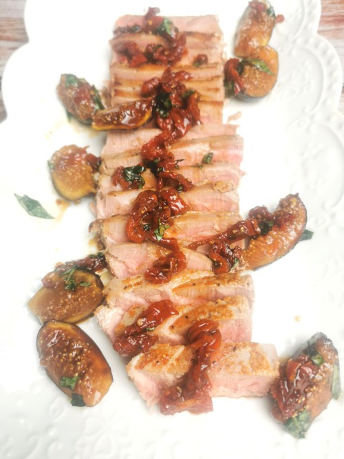Tuna with sundried tomatoes, basil, fig on a white serving platter