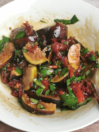 Tuna with sundried tomatoes and fig - salad topping in white mixing bowl