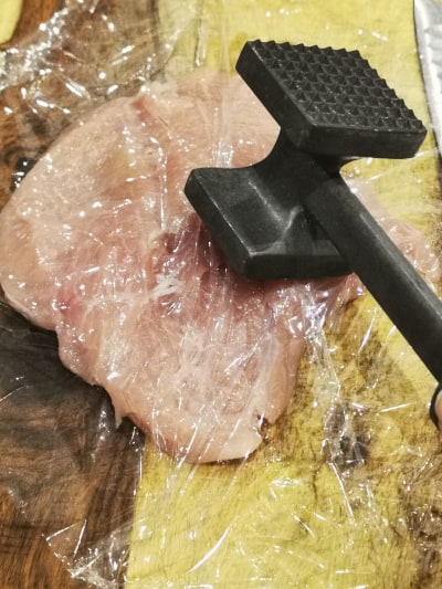 chicken breast covered with plastic wrap and beat with meat mallet