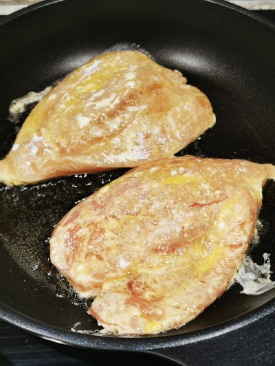 chicken breasts frying on skillet