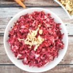sweet and crunchy beet salad in a white serving plate.