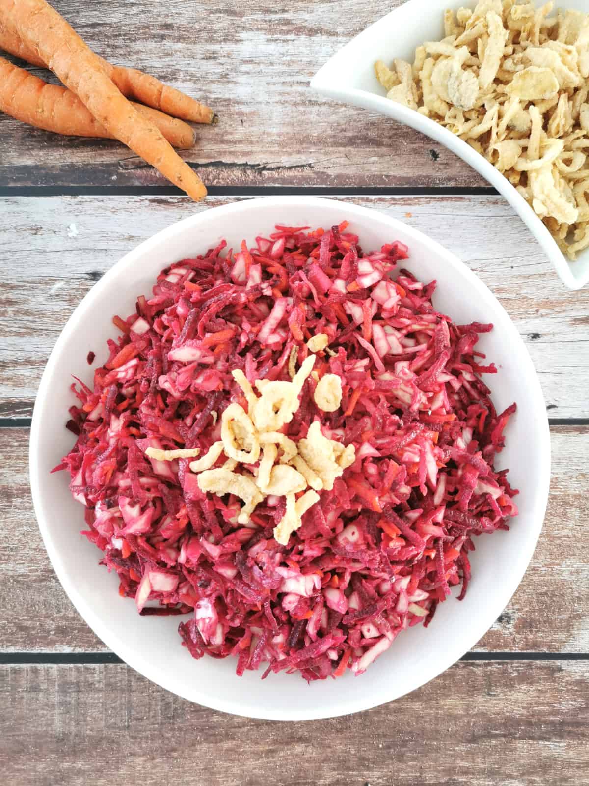 sweet and crunchy beet salad in a white serving plate.