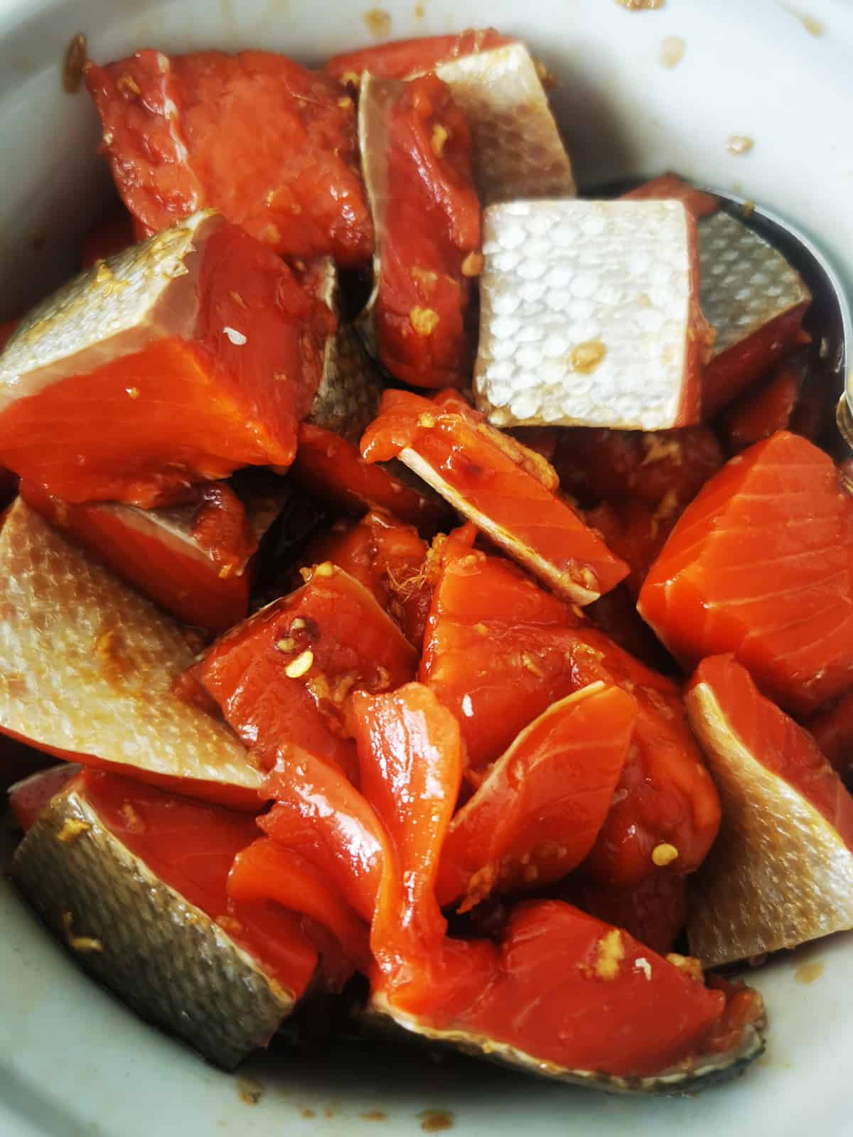 salmon marinating in large bowl.