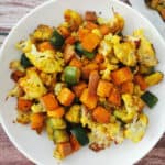 Healthy turmeric oven roasted vegetables in a white platter.