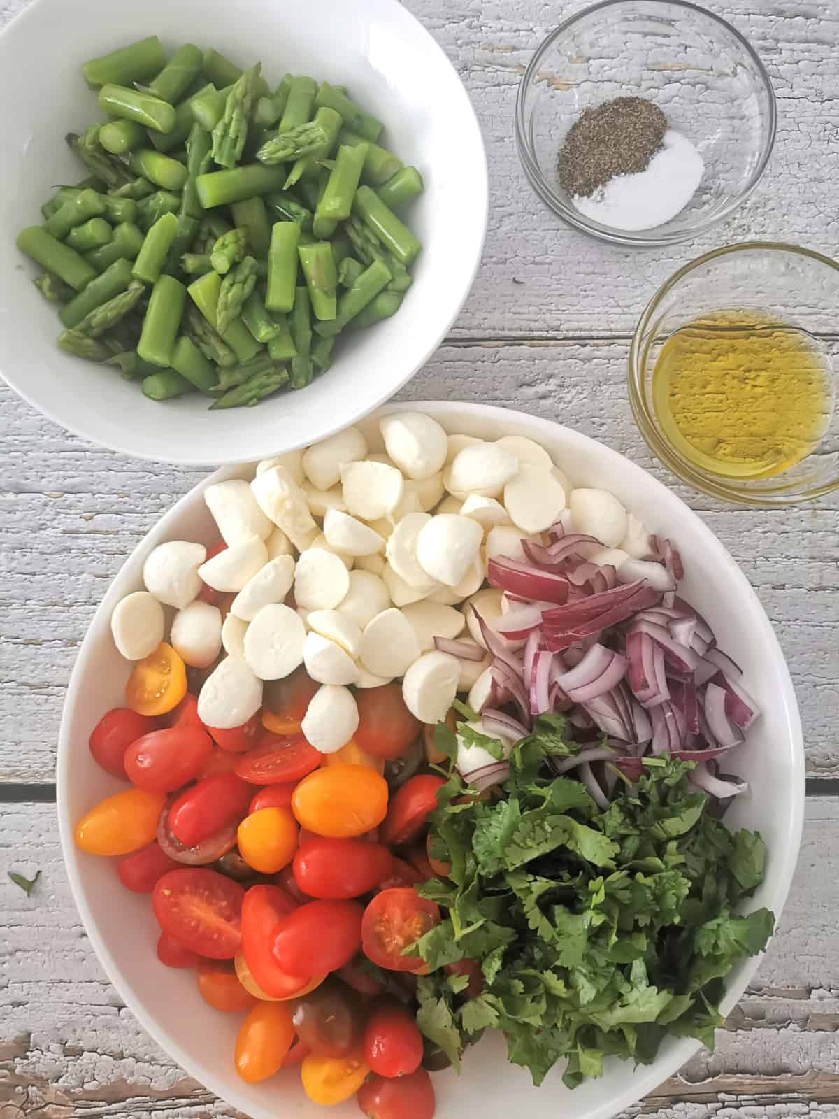 cooked asparagus on the side of other ingredients of the salad.