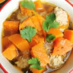 Meatball soup with sweet potatoes and butternut squash in a soup bowl.