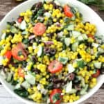 turmeric couscous salad in a white bowl.