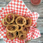 Baked Beer-Battered Onion Rings on checkered paper.