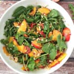 Arugula and Spinach Salad in a large white salad bowl.