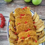 Cinnamon Crunch French Toast on a white serving platter with apples on the side.