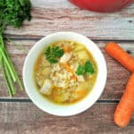 hearty pickle soup in a small white bowl.