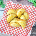 Empanada Caprese on red checkered paper.