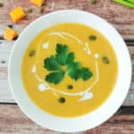 Cauliflower and Pumpkin Soup in a white bowl.