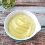 Homemade Mayonnaise with Avocado Oil in a blue measuring cup.