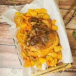 Slow Cooker Gammon (Ham) on a parchment paper lined baking dish.
