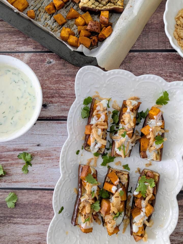 Roasted Eggplant and Sweet Potatoes on a white platter.
