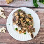 Veal Chops in Mushroom Sauce in a white plate.