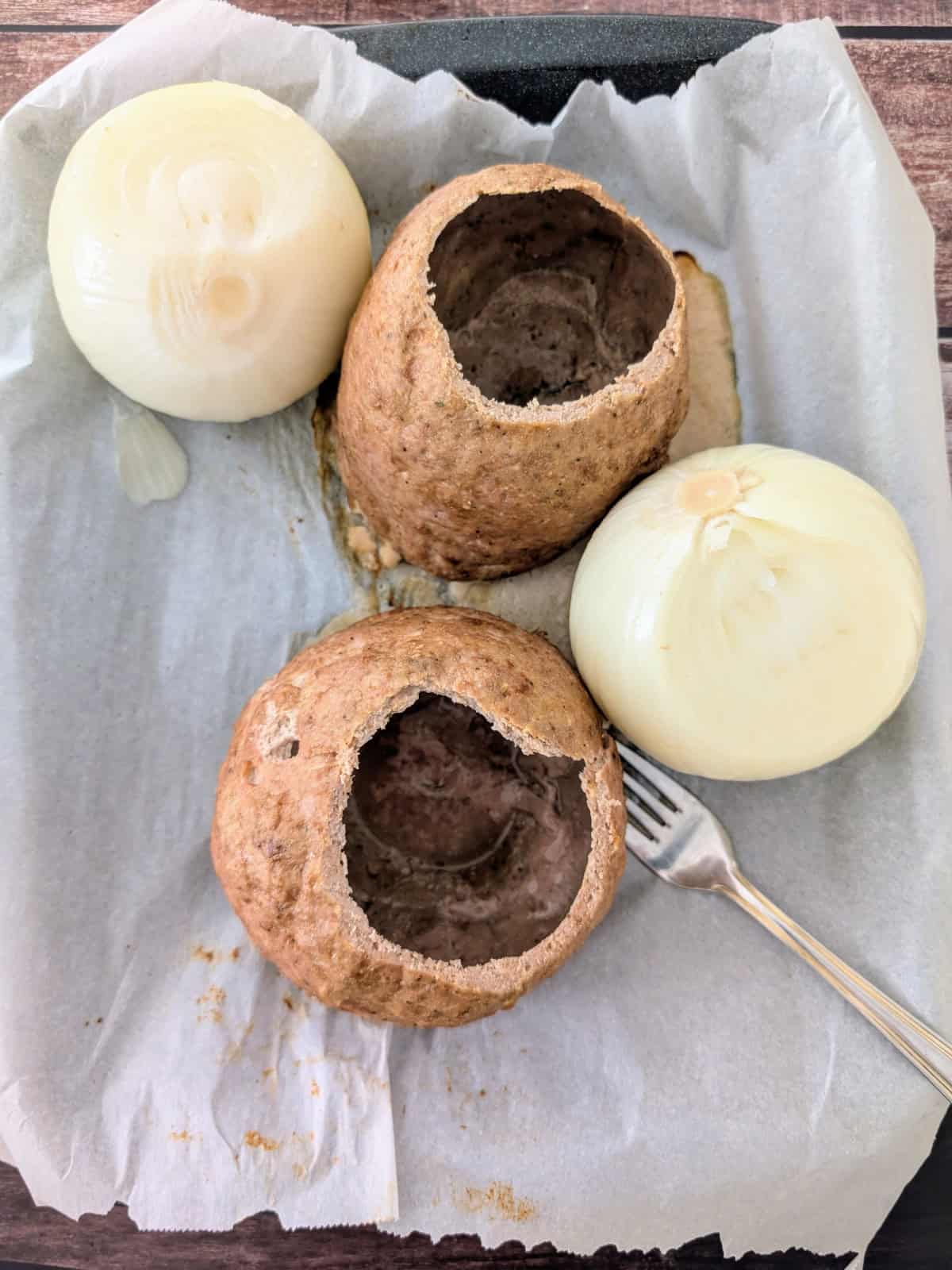 hollowed out meatballs with cooked onions on the side.