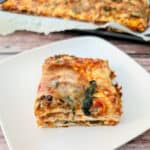 matzo lasagna on a square white plate for Matzo Lasagna Recipe (perfect for Passover).