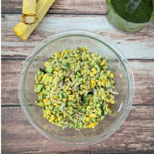 Pesto Orzo Salad with Grilled Corn in a large glass mixing bowl.