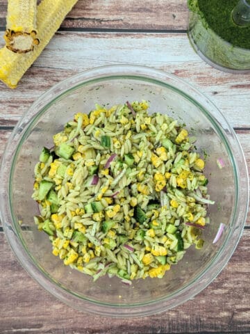 Pesto Orzo Salad with Grilled Corn in a large glass mixing bowl.