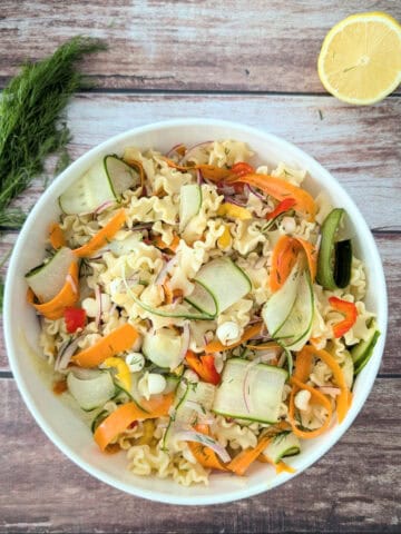 One-Pot Vegetable Pasta Salad with Ribbon-Style Veggies in a white salad bowl.
