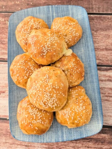 oven baked crab pockets on a blue platter.