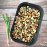 2-Ingredient Air Fryer Bacon Potatoes in an air-fryer tray.