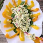 Mediterranean egg salad with bell pepper scoops served on greens.