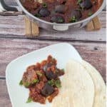 One-Pan Braised Indian Eggplant in Spiced Marinara on a white plate.