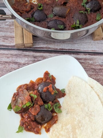 One-Pan Braised Indian Eggplant in Spiced Marinara on a white plate.