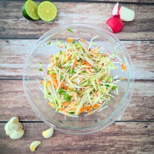Crunchy kohlrabi carrot cucumber and radish salad with lime garlic dressing.