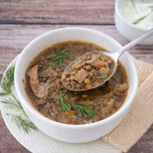 Turkey Lentil Soup with Cabbage & Bacon in a white bowl.