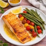 Easy healthy lemon Dijon honey baked salmon with green beans and tomatoes.