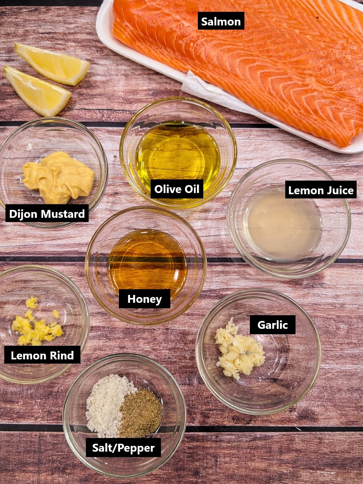 Ingredients for lemon Dijon honey baked salmon including fresh salmon, mustard, oil, garlic and lemon.