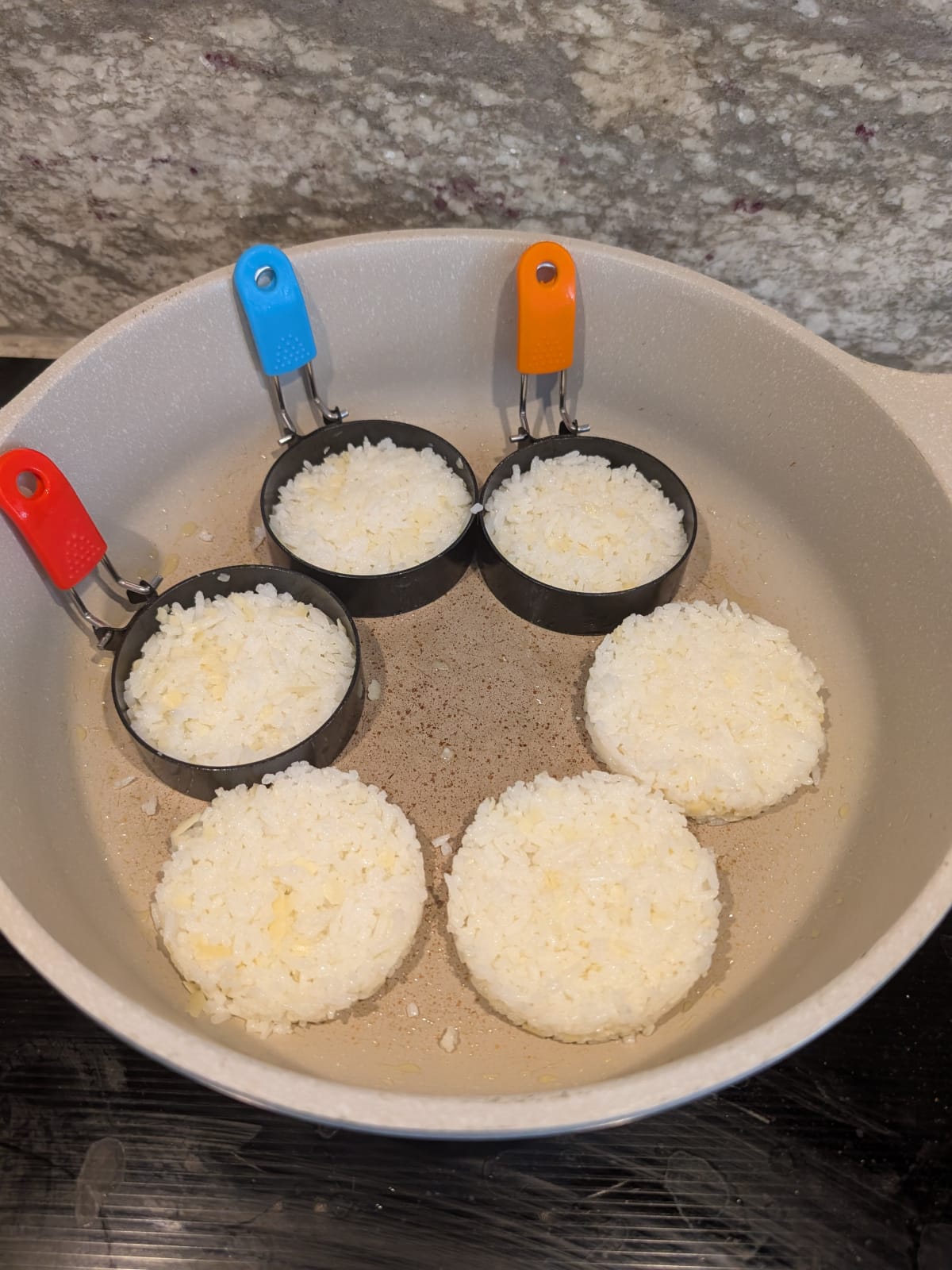 Shaping rice mixture into small round patties.