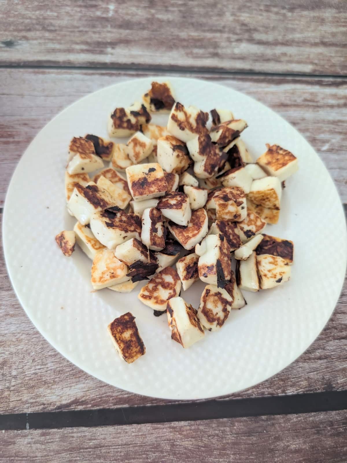 Pan-fried halloumi slices, golden and crispy.
